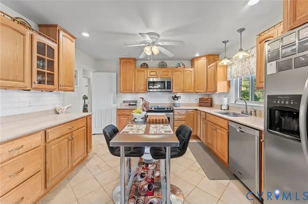 a kitchen with stainless steel appliances a stove a sink and a refrigerator