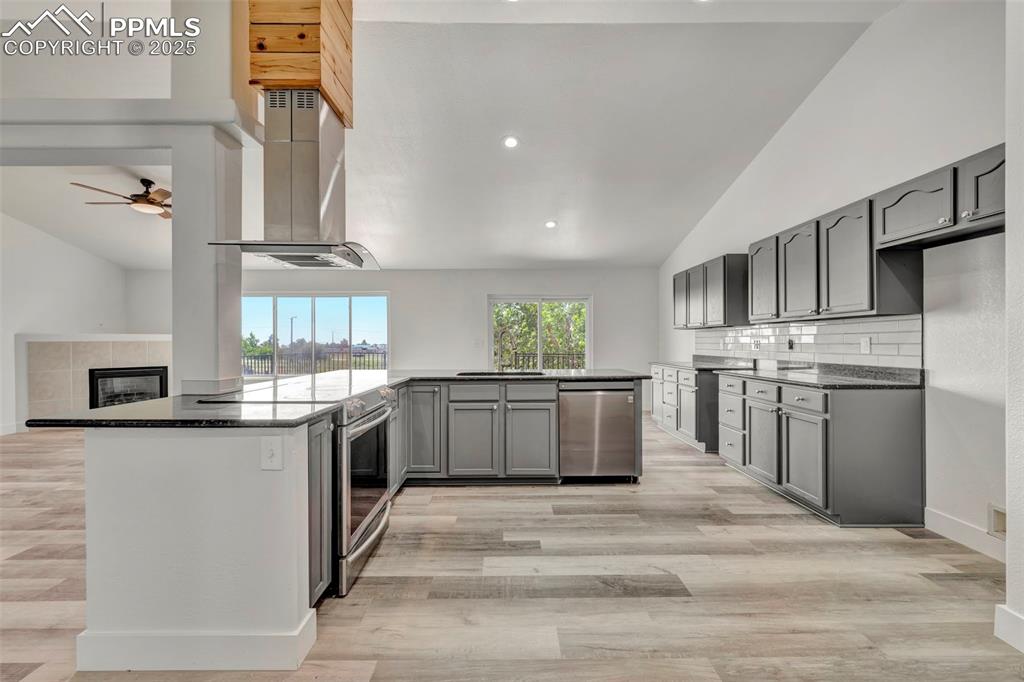 7841 Fort Smith Road Peyton, CO 80831 - Photo 7 of 37 Gleaming granite and tile backsplash! Modern meets rustic with the range vent