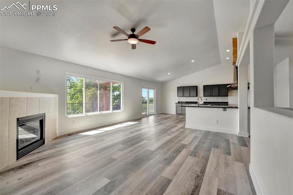 7841 Fort Smith Road Peyton, CO 80831 - Photo 8 of 37 Spacious living room and dining area with a sneak preview of the wonderful back deck. Also, featuring a gas fireplace for those cool fall days and those cold blustery winter days!