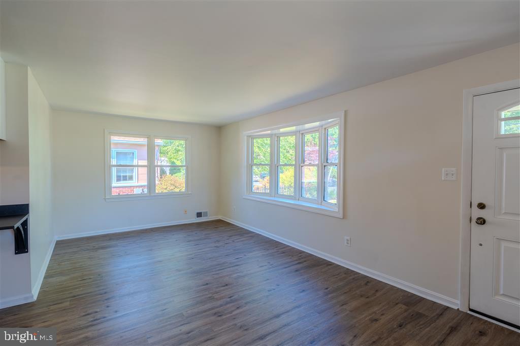 12324 Centerhill Street Silver Spring, MD 20902 - Photo 7 of 24 an empty room with wooden floor and windows