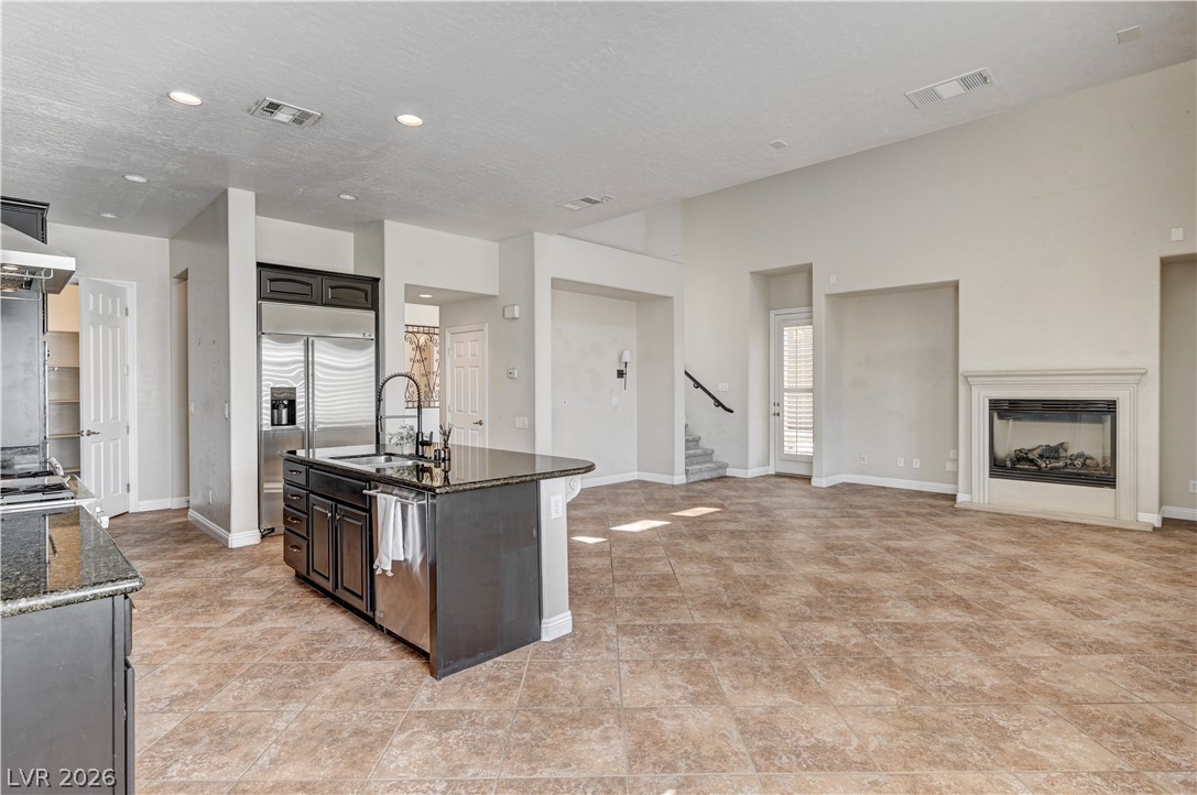 2793 Rosenhearty Drive Henderson, NV 89044 - Photo 15 of 85 Great room with secondary stairs and gas fireplace.