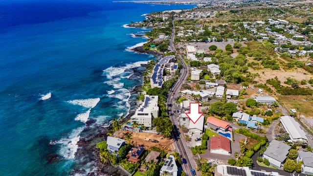 an aerial view of a house with a ocean view