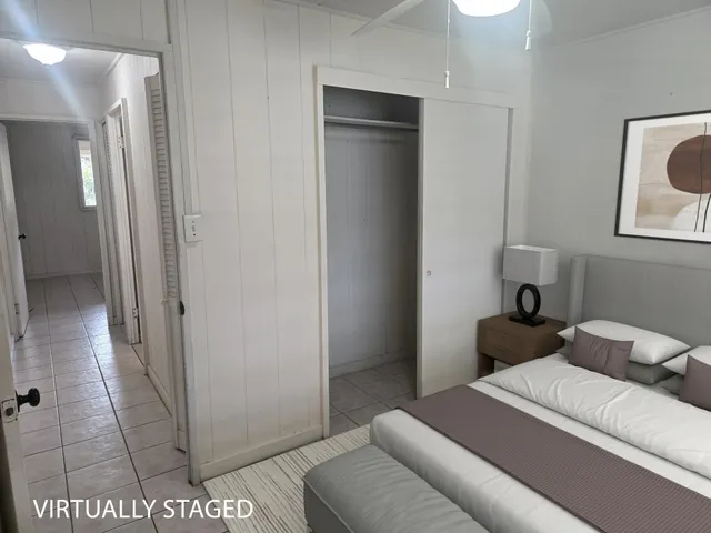 a bedroom with a bed and a painting on the wall