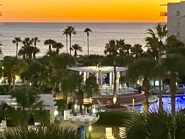 a living room with furniture a dining table and a chandelier