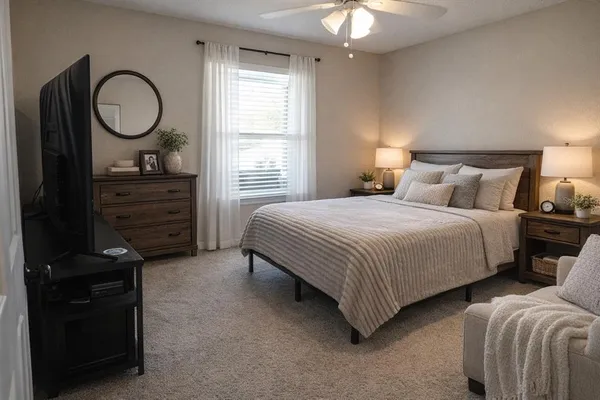 a bedroom with bed and a window
