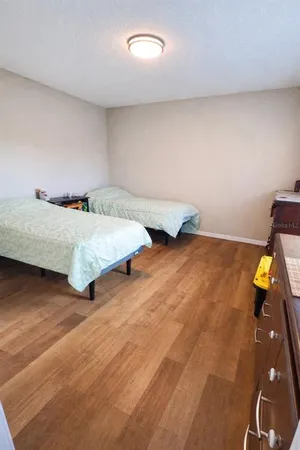 a bedroom with a bed and a desk