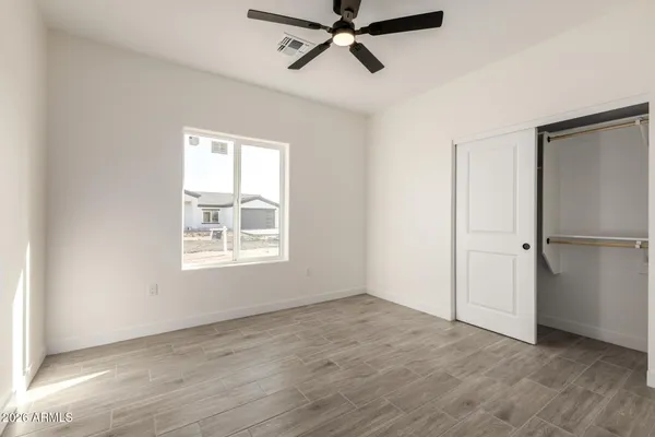 an empty room with wooden floor and window