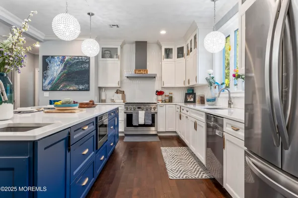 a kitchen with cabinets a window and stainless steel appliances