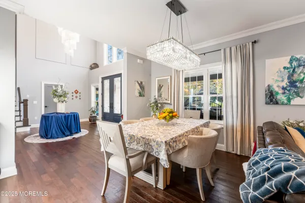 a view of a dining room with furniture wooden floor and chandelier