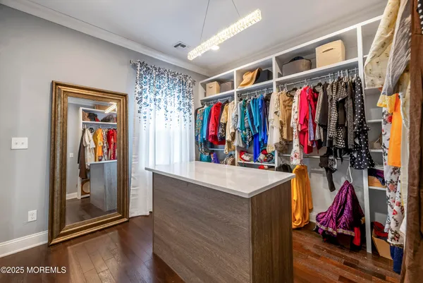 a view of walk in closet with clothes