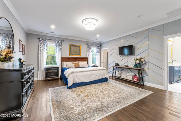 a bedroom with a bed flat screen tv and a large window