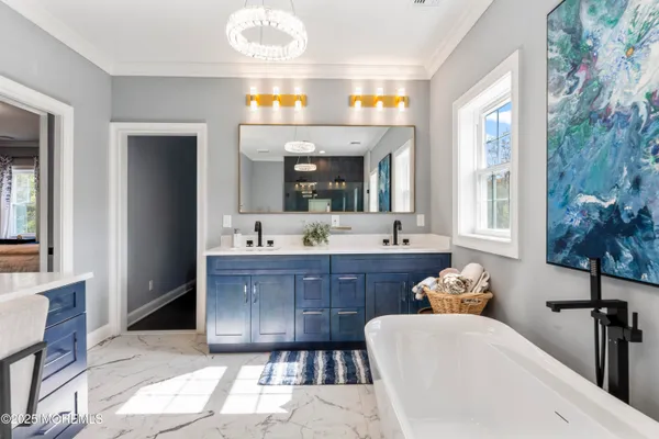 a spacious bathroom with a sink a mirror and a bathtub