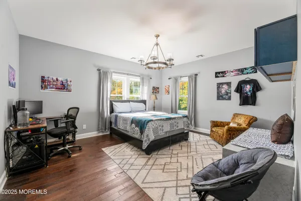 a bedroom with furniture and a chandelier