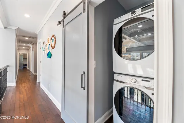 a view of a hallway with washer and dryer