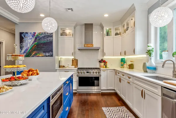 a kitchen with stainless steel appliances granite countertop a stove and a sink