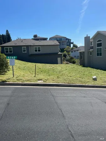 a view of a house with a yard and a large window