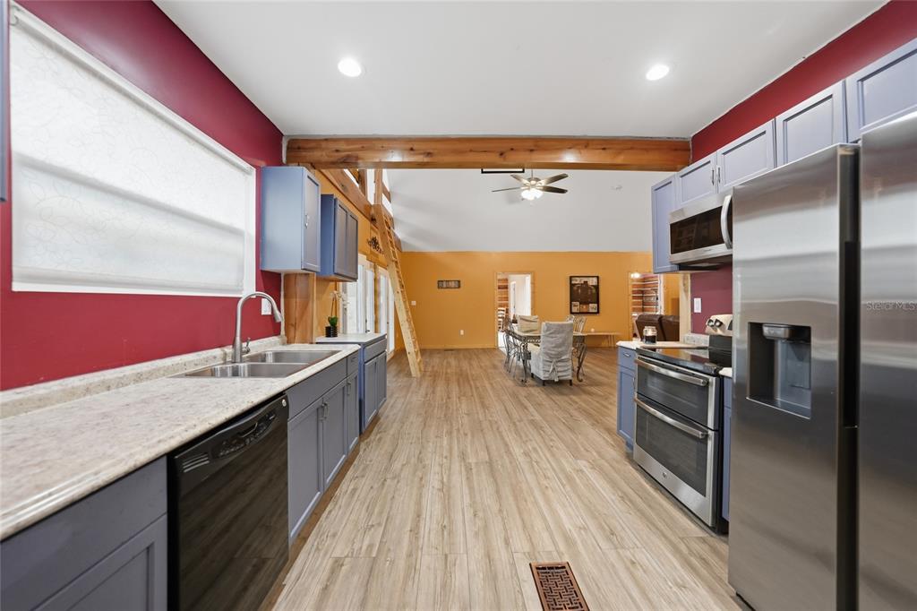 9796 Southwest Southern Dreams Road Arcadia, FL 34269 - Photo 15 of 72 a kitchen with stainless steel appliances granite countertop lots of counter top space and wooden floor