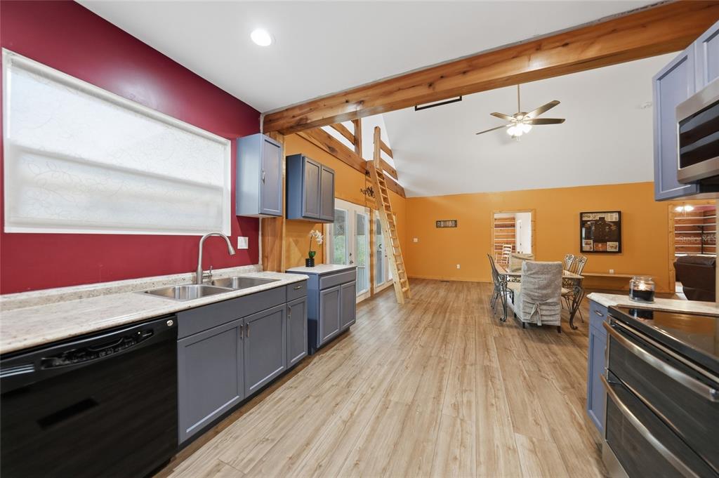 9796 Southwest Southern Dreams Road Arcadia, FL 34269 - Photo 16 of 72 a kitchen with stove and wooden floor
