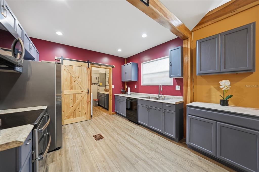 9796 Southwest Southern Dreams Road Arcadia, FL 34269 - Photo 18 of 72 a kitchen with cabinets a sink and appliances