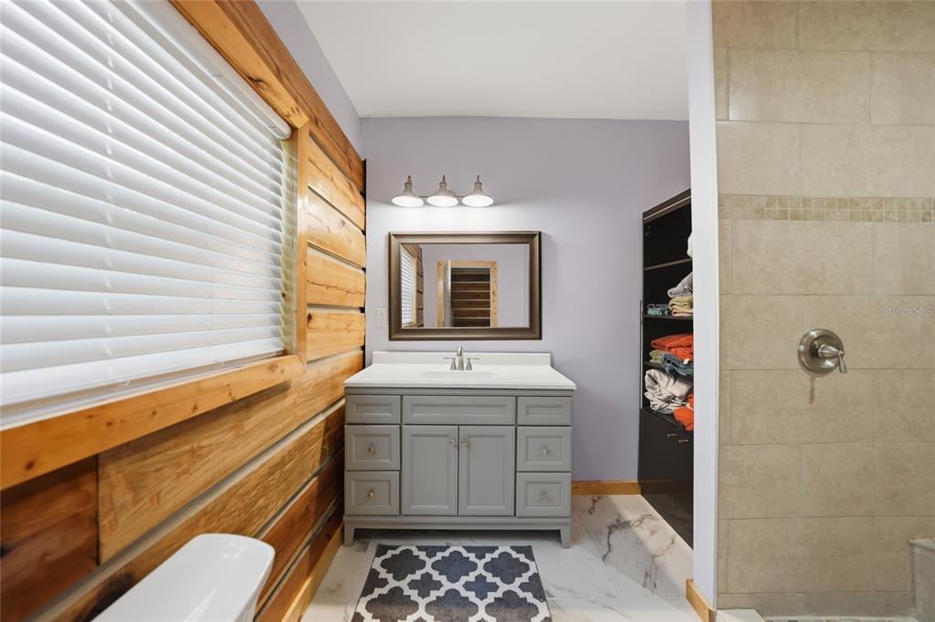 9796 Southwest Southern Dreams Road Arcadia, FL 34269 - Photo 23 of 72 a bathroom with a sink a toilet and shower