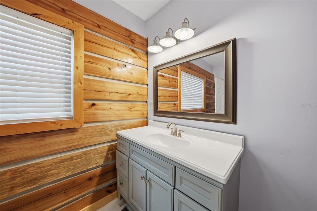 9796 Southwest Southern Dreams Road Arcadia, FL 34269 - Photo 24 of 72 a bathroom with a sink and a large mirror