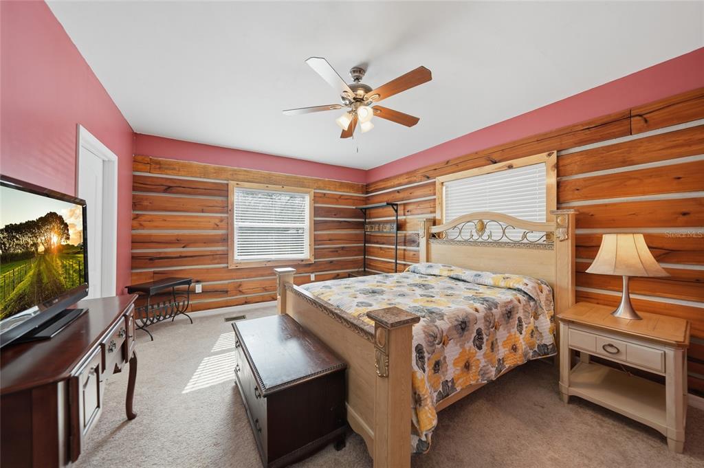 9796 Southwest Southern Dreams Road Arcadia, FL 34269 - Photo 26 of 72 a bedroom with a bed and a flat screen tv