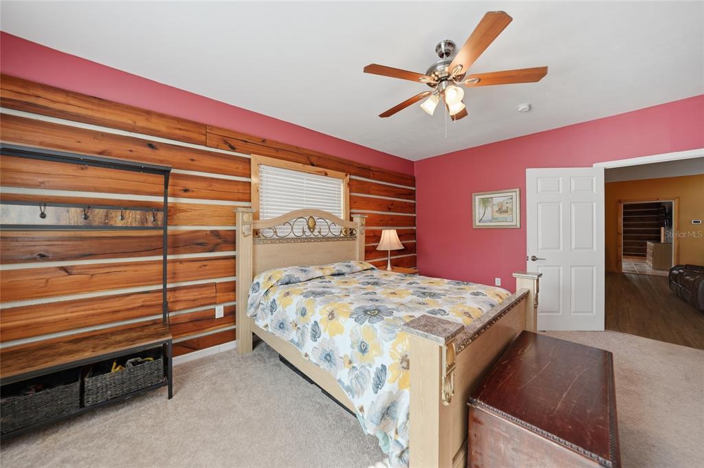 9796 Southwest Southern Dreams Road Arcadia, FL 34269 - Photo 27 of 72 a bedroom with a bed and a chandelier