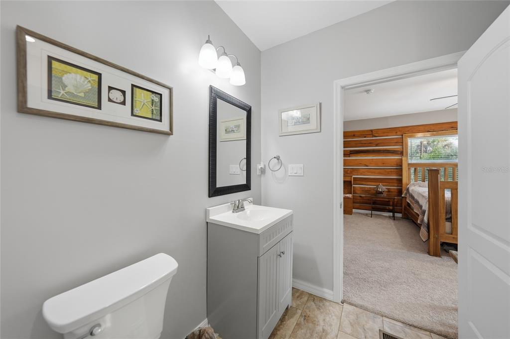 9796 Southwest Southern Dreams Road Arcadia, FL 34269 - Photo 30 of 72 a bathroom with a toilet sink and mirror