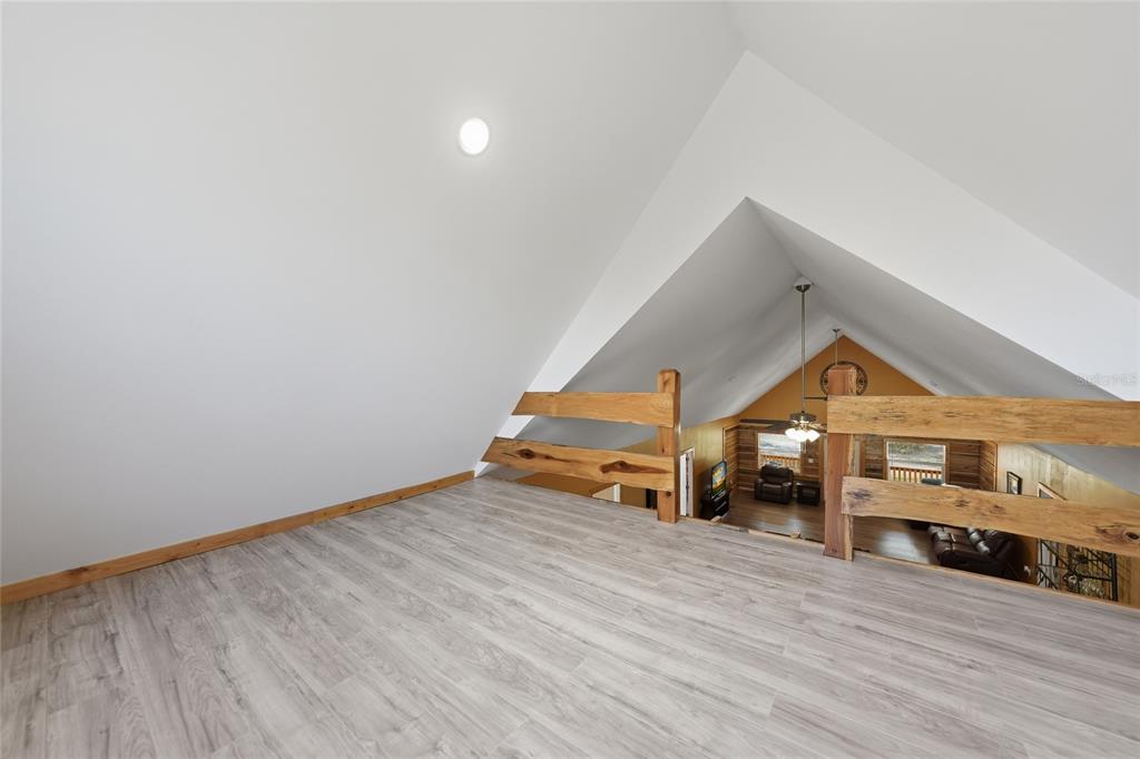 9796 Southwest Southern Dreams Road Arcadia, FL 34269 - Photo 34 of 72 a view of an empty room with wooden floor windows and a fireplace
