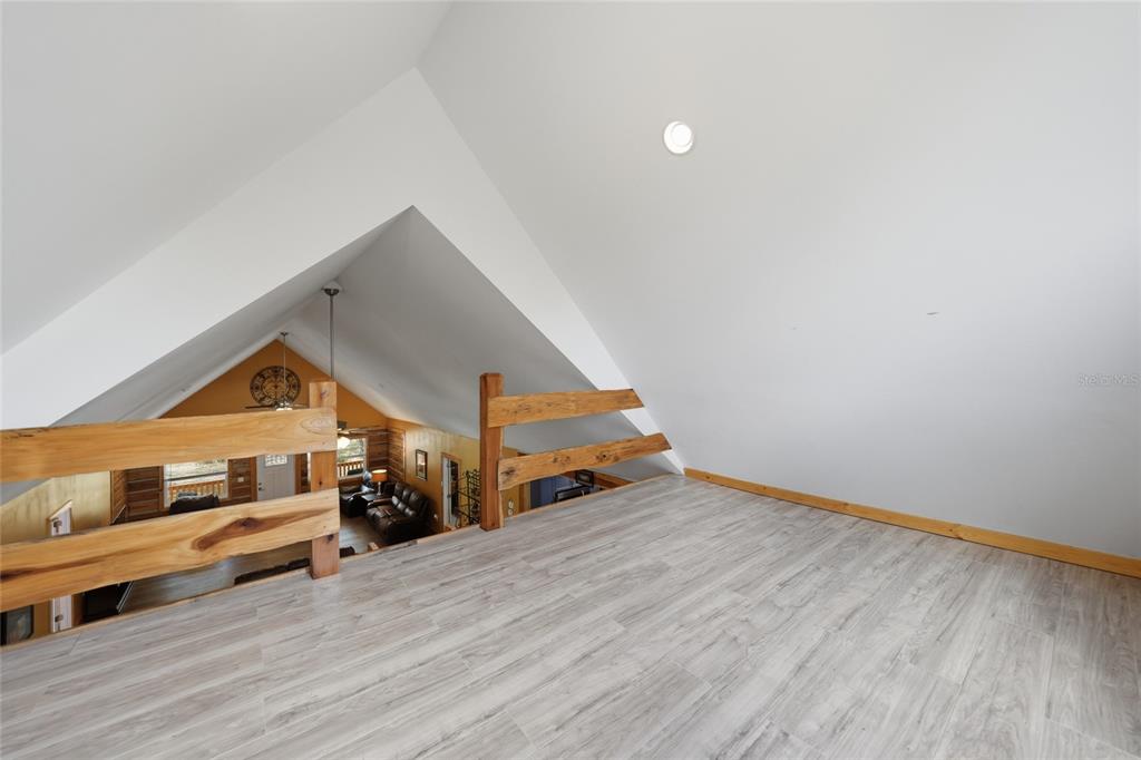 9796 Southwest Southern Dreams Road Arcadia, FL 34269 - Photo 35 of 72 a living room with a dresser and a wooden floor