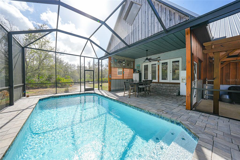 9796 Southwest Southern Dreams Road Arcadia, FL 34269 - Photo 49 of 72 a swimming pool with outdoor seating and yard