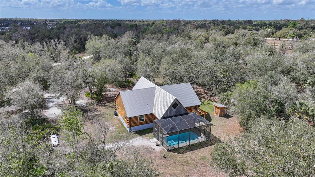 9796 Southwest Southern Dreams Road Arcadia, FL 34269 - Photo 64 of 72 an aerial view of a chairs and table in the backyard