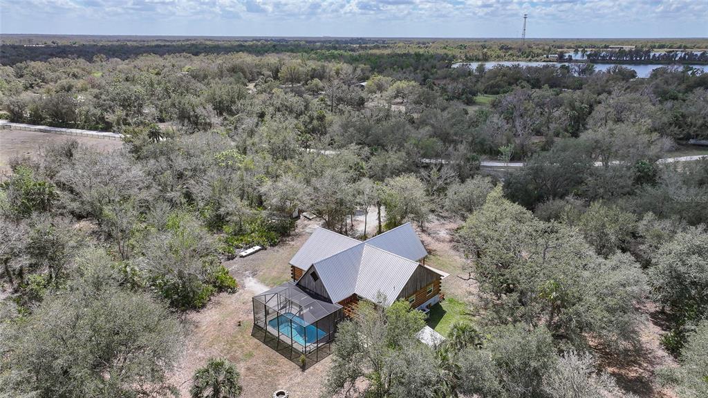 9796 Southwest Southern Dreams Road Arcadia, FL 34269 - Photo 65 of 72 an aerial view of a house with a yard and trees