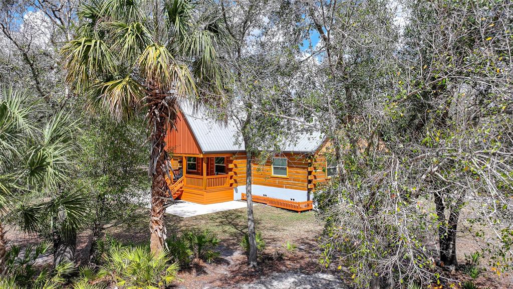 9796 Southwest Southern Dreams Road Arcadia, FL 34269 - Photo 70 of 72 an aerial view of a house with swimming pool and large trees