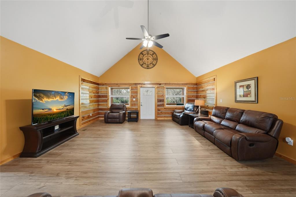 9796 Southwest Southern Dreams Road Arcadia, FL 34269 - Photo 7 of 72 a living room with furniture a flat screen tv and kitchen view