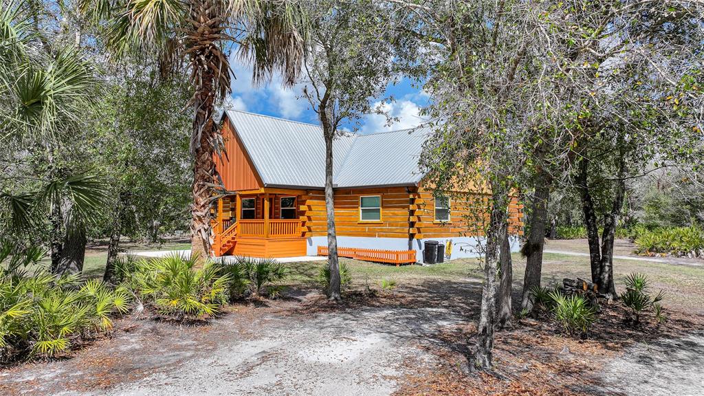 9796 Southwest Southern Dreams Road Arcadia, FL 34269 - Photo 71 of 72 an aerial view of a house with garden space and sitting area