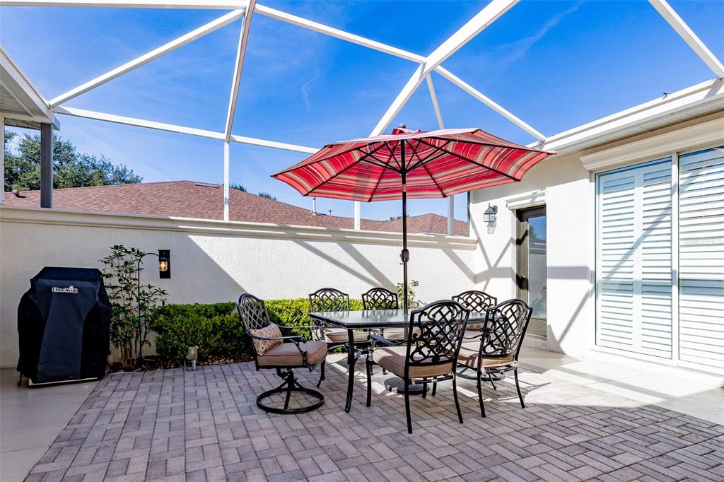 1250 Southwest 152nd Lane Ocala, FL 34473 - Photo 12 of 88 a view of a patio with table and chairs under an umbrella