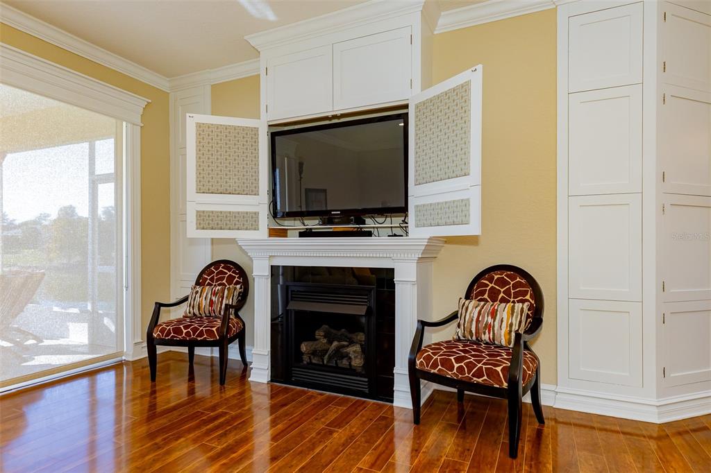 1250 Southwest 152nd Lane Ocala, FL 34473 - Photo 32 of 88 a living room with furniture a fireplace and a flat screen tv