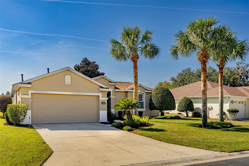 1250 Southwest 152nd Lane Ocala, FL 34473 - Photo 4 of 88 a front view of a house with garden