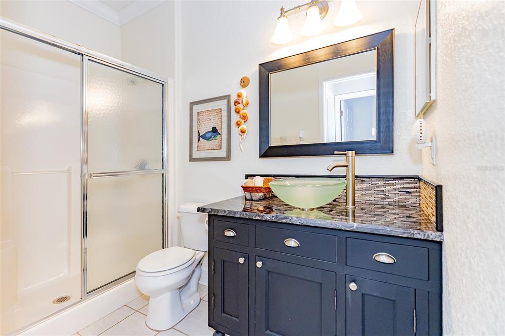 1250 Southwest 152nd Lane Ocala, FL 34473 - Photo 48 of 88 a bathroom with a granite countertop toilet sink and mirror
