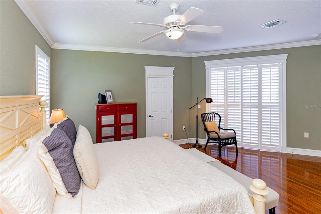 1250 Southwest 152nd Lane Ocala, FL 34473 - Photo 51 of 88 a bedroom with a bed and a chandelier