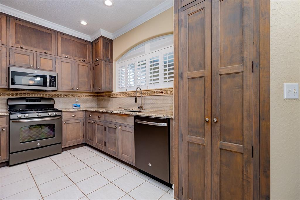 1250 Southwest 152nd Lane Ocala, FL 34473 - Photo 59 of 88 a kitchen with stainless steel appliances granite countertop a refrigerator and a stove top oven