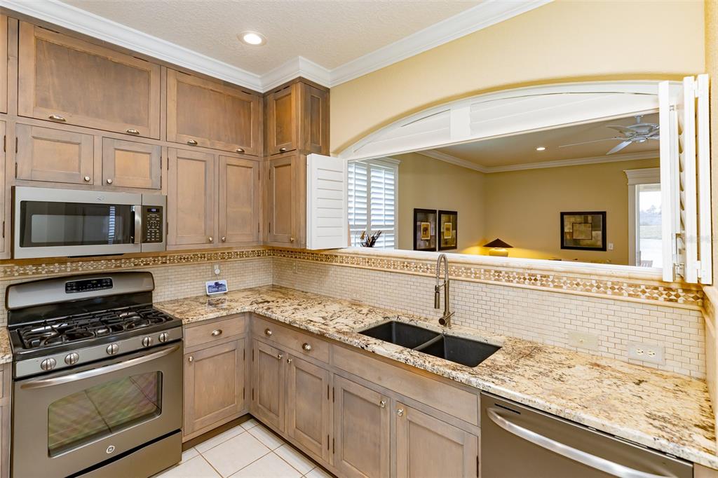 1250 Southwest 152nd Lane Ocala, FL 34473 - Photo 64 of 88 a kitchen with stainless steel appliances granite countertop a sink stove and oven