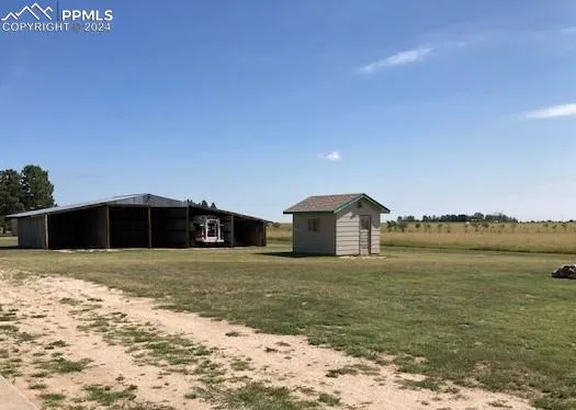 a view of a house with a yard and garage
