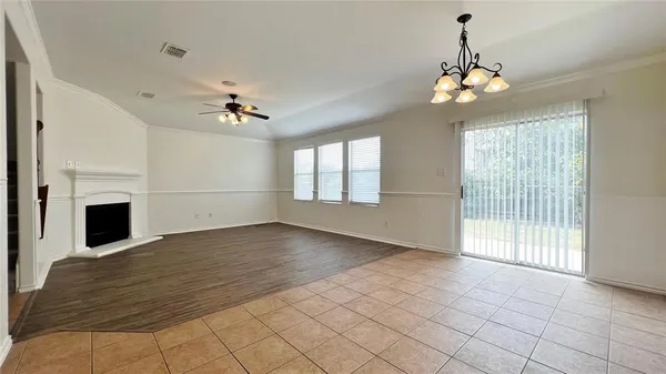 a view of an empty room with a fireplace and a window