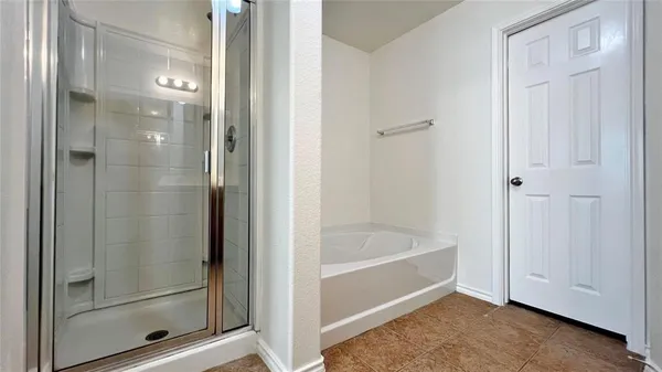 a bathroom with a bathtub and shower