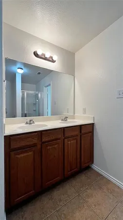a bathroom with a double vanity sink and a mirror