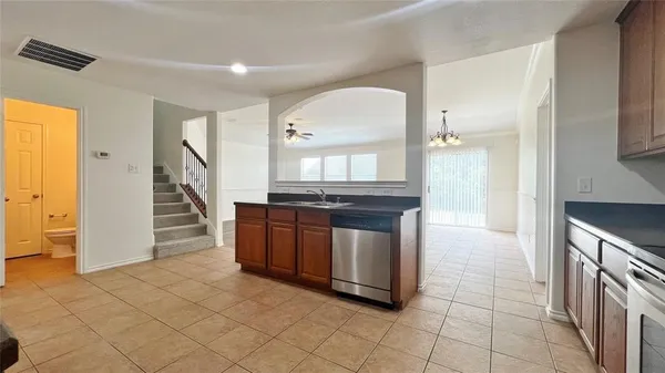 a kitchen with granite countertop a sink and a stove