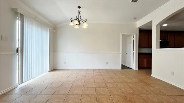 a view of an empty room with glass door