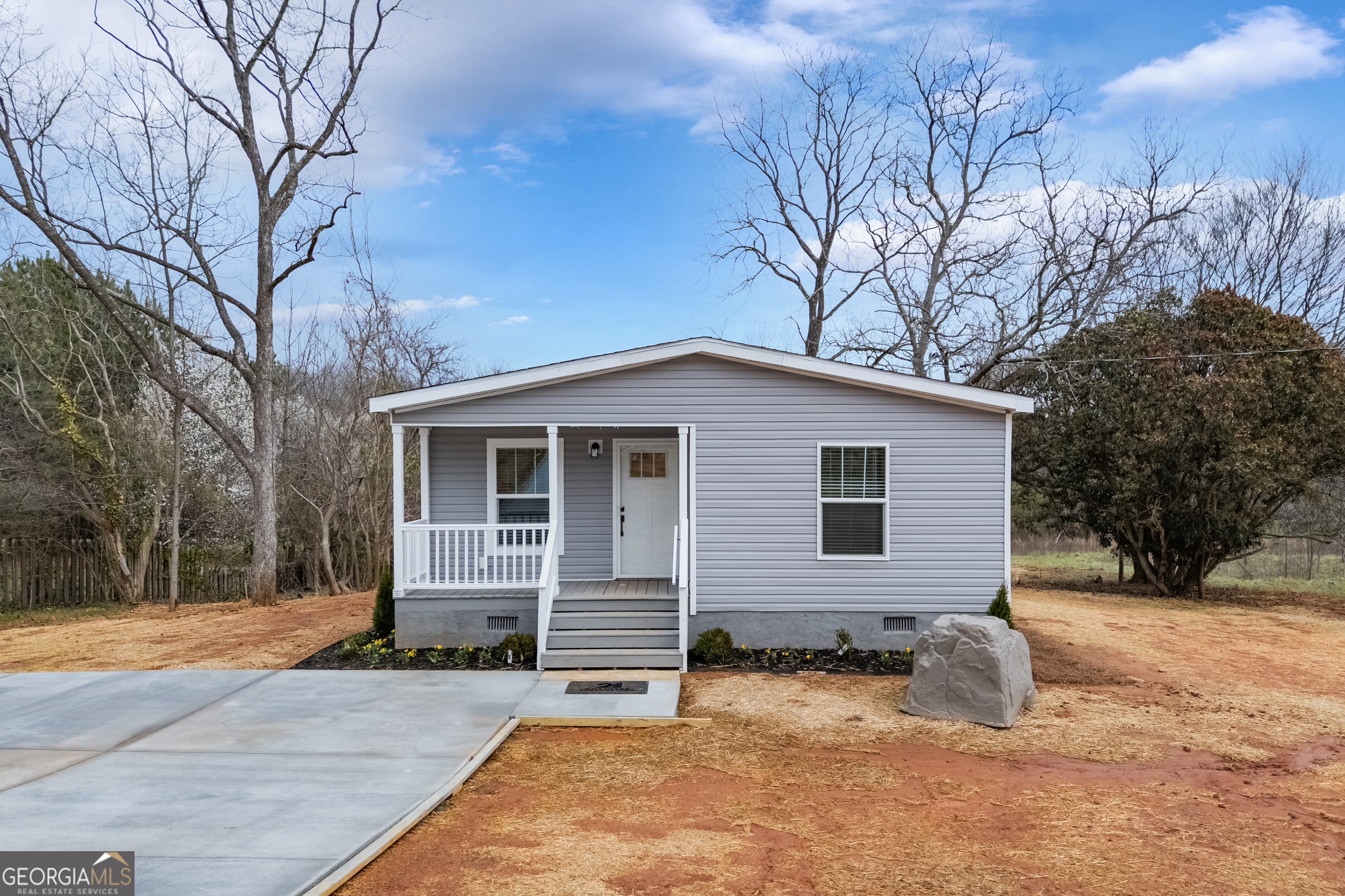 a view of a house with a yard covered in snow